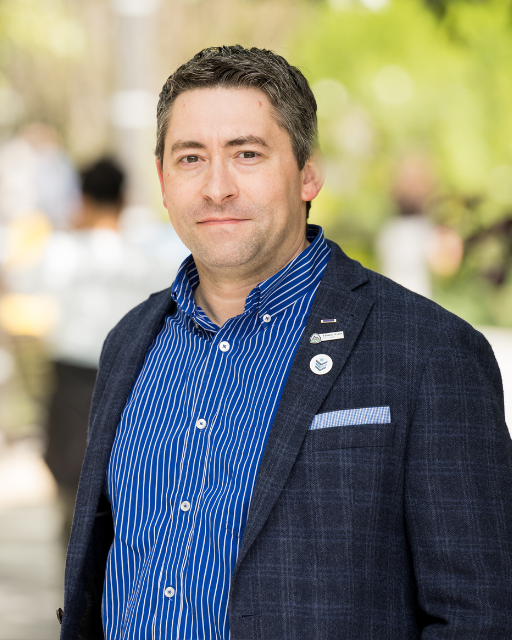 Man with professional blazer looking at the camera